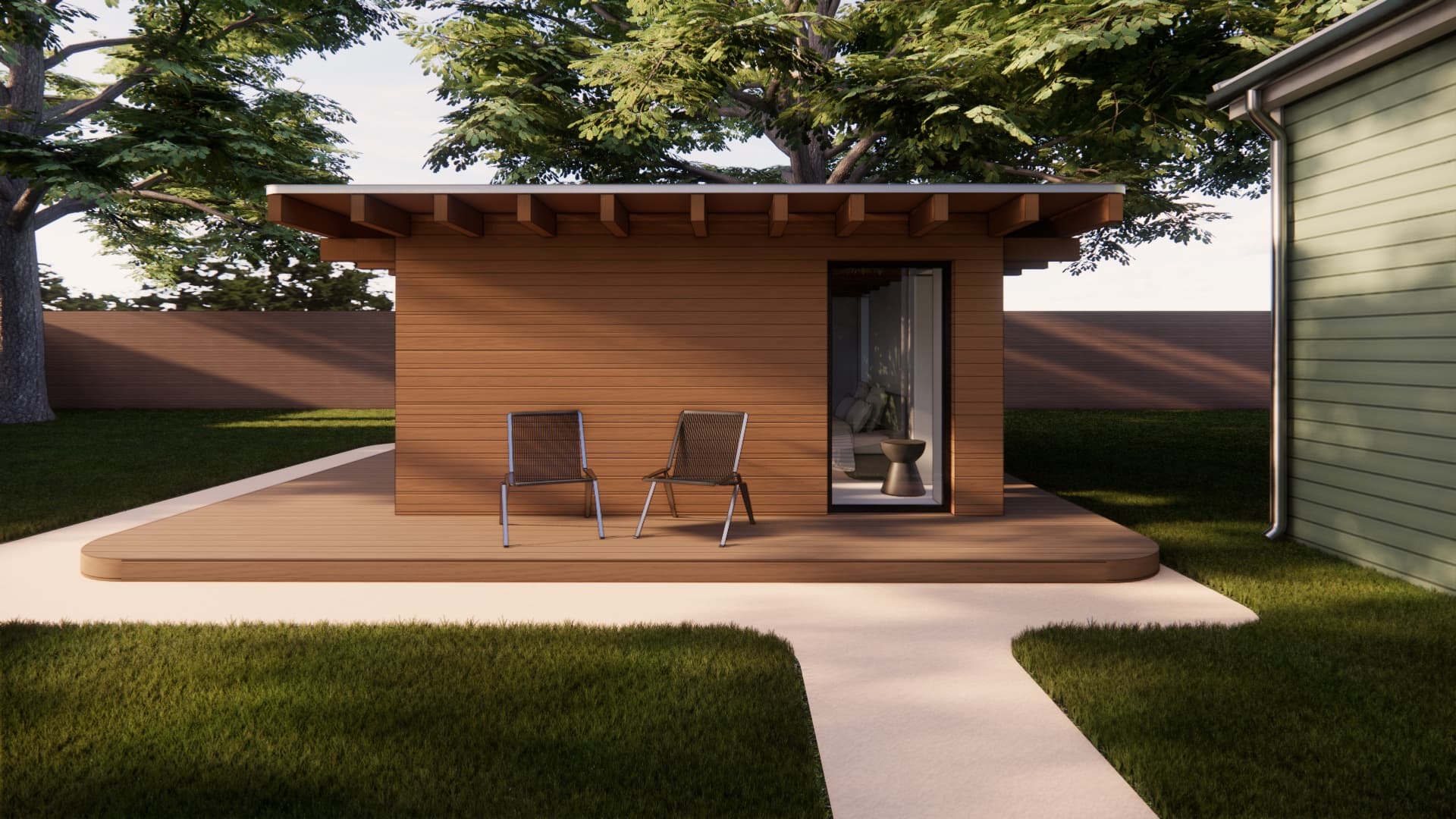 A Member Den unit sited in a landscaped backyard with a deck and walkway, showing how a unit fits a property.